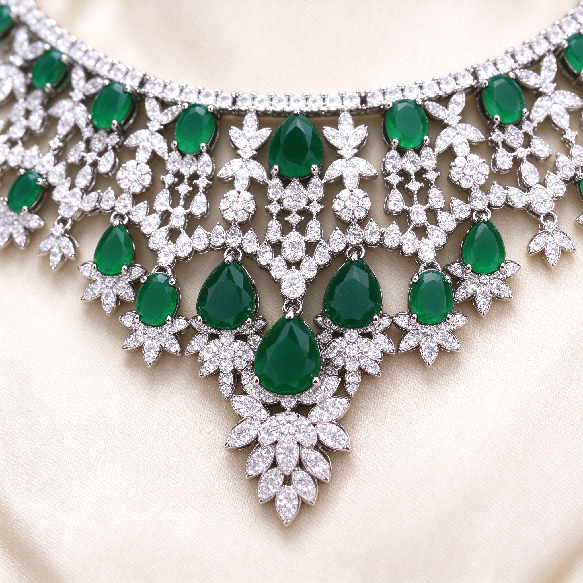 Macro detail of The Rain Crystal Parure V-shaped emerald CZ necklace