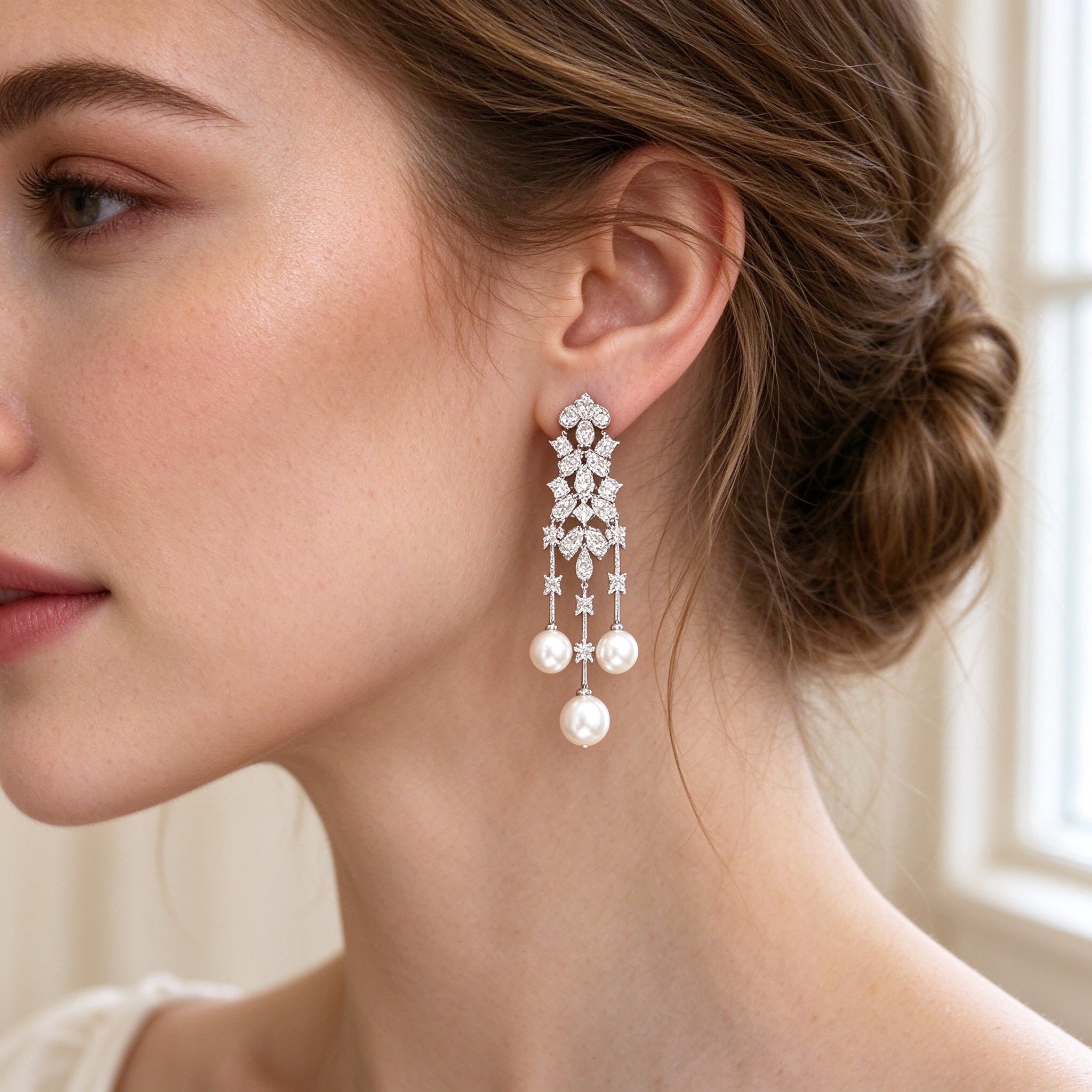 Close-up of linear pearl-tassel CZ drop earrings
