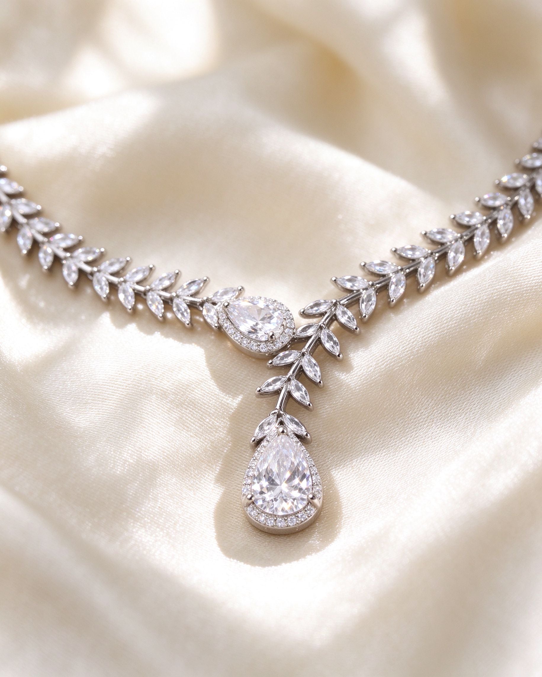 Macro of marquise-cut laurel leaves and pear-cut CZ pendant on rhodium silver-tone